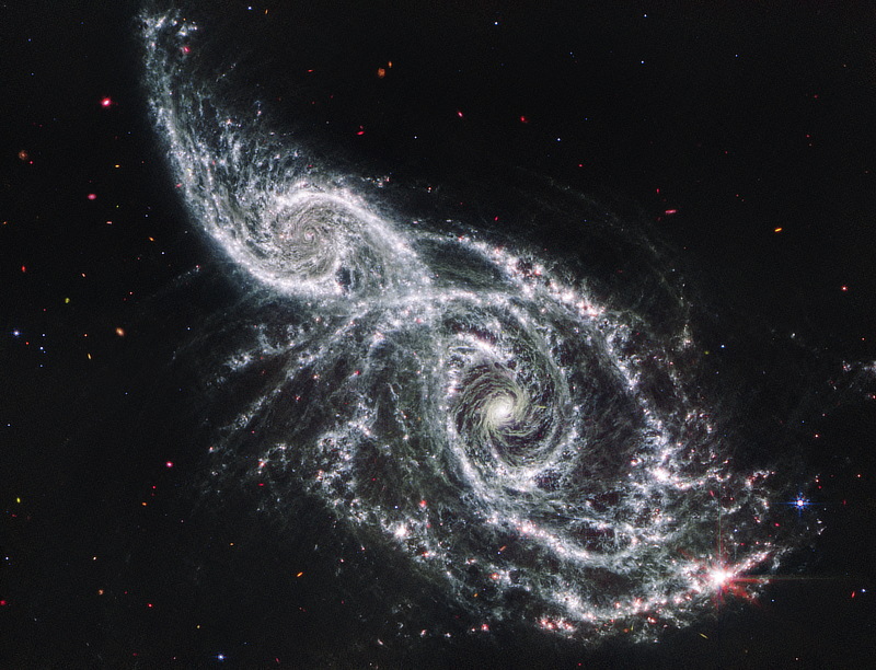 A mid-infrared image of the interacting galaxies NGC 2207 and IC 2163 in Canis Major is provided by NASA, ESA, CSA, STScI